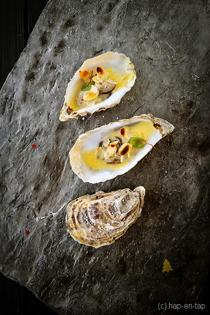 Gegratineerde oesters in een saffraan botersaus
